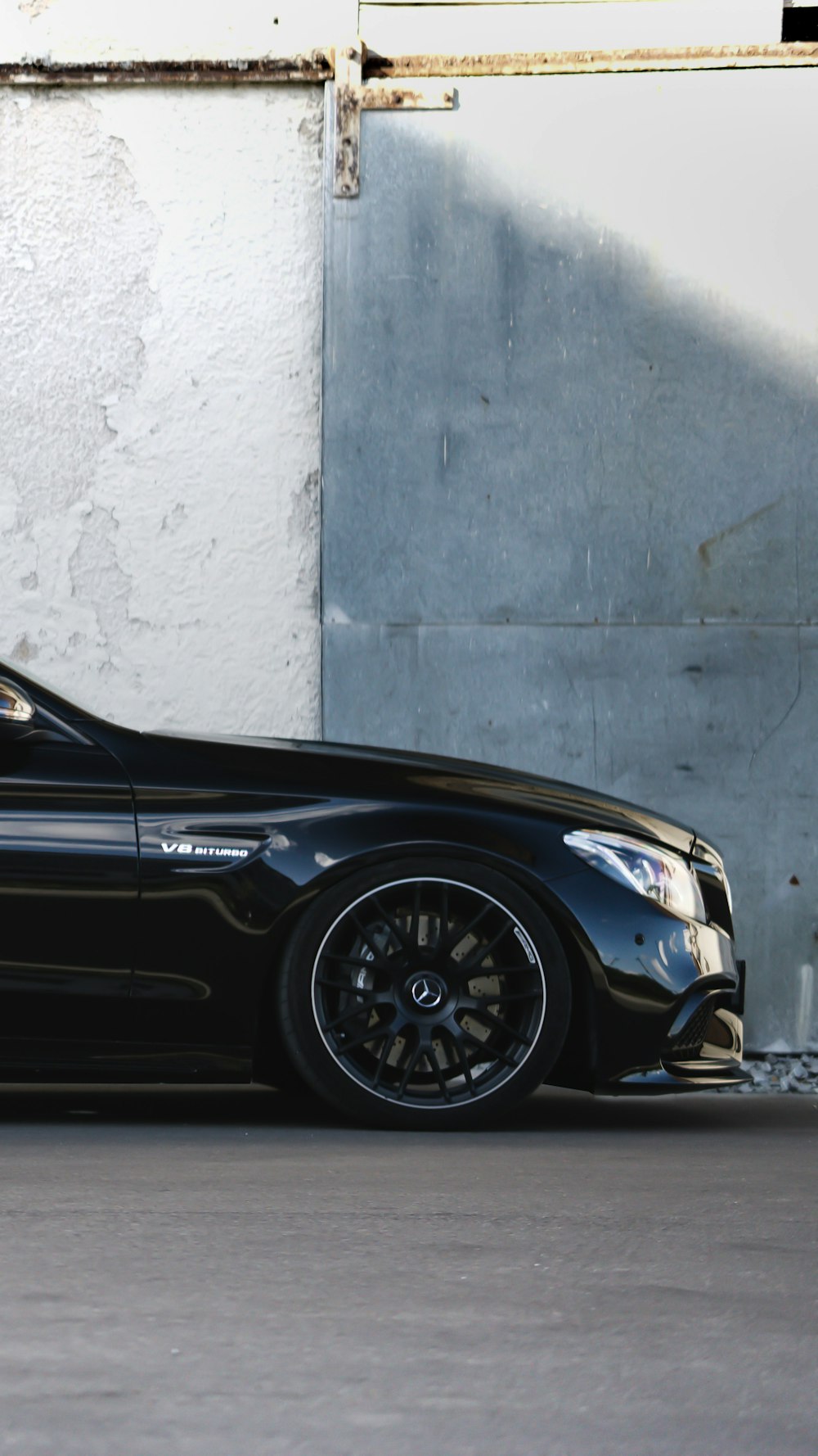 a black car parked in front of a building