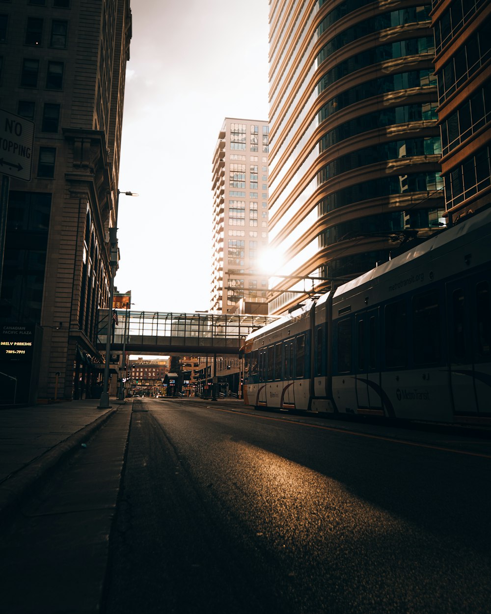 gray concrete road between high rise buildings during daytime