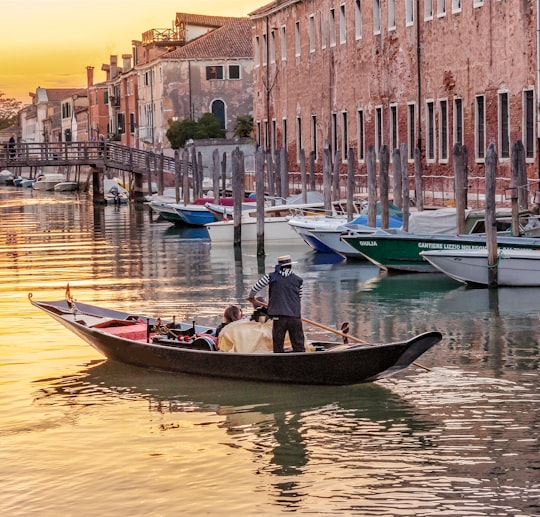 people riding on boat on river during daytime in Cannaregio Italy