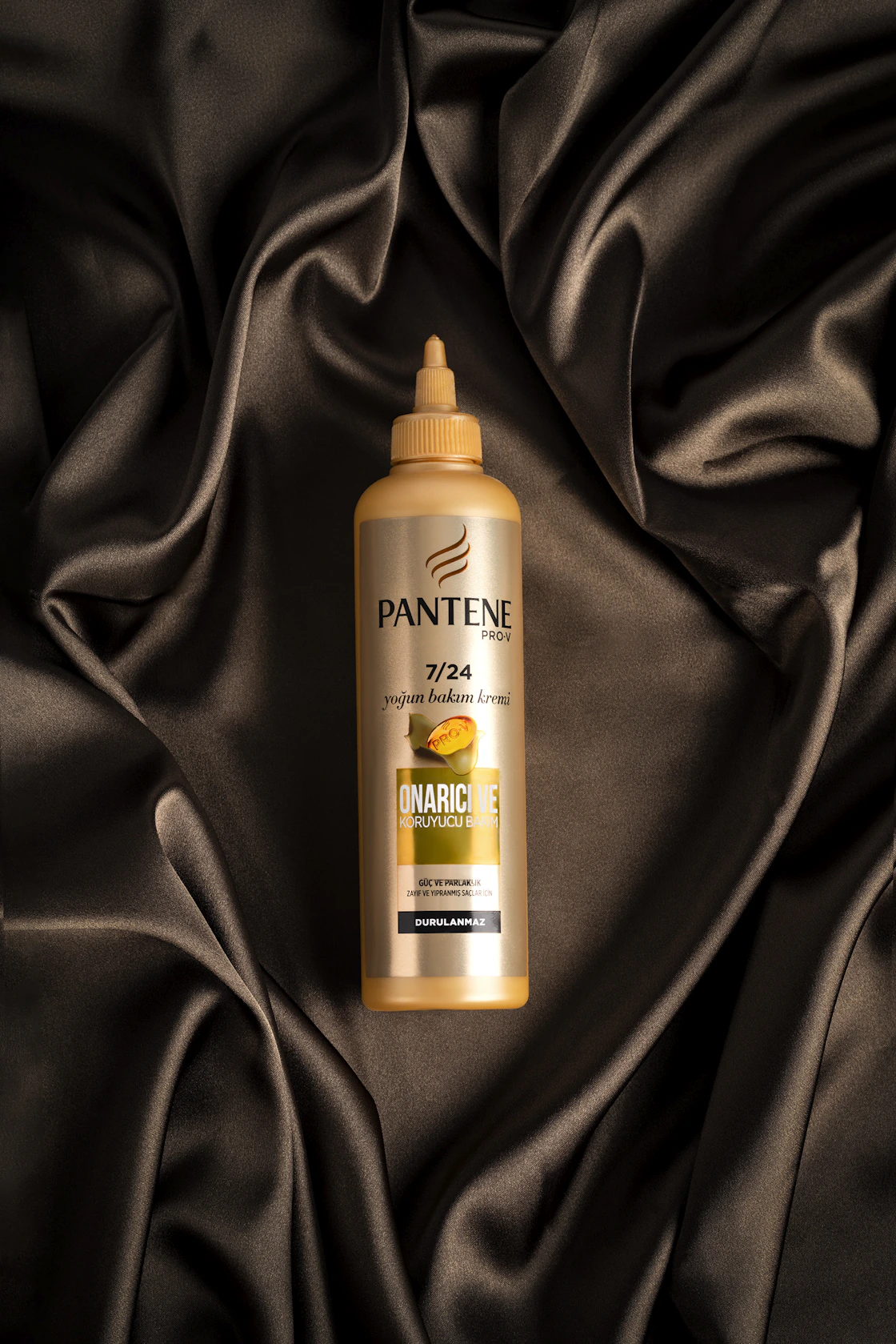 Natural hair care bottles and botanical ingredients on a refined surface