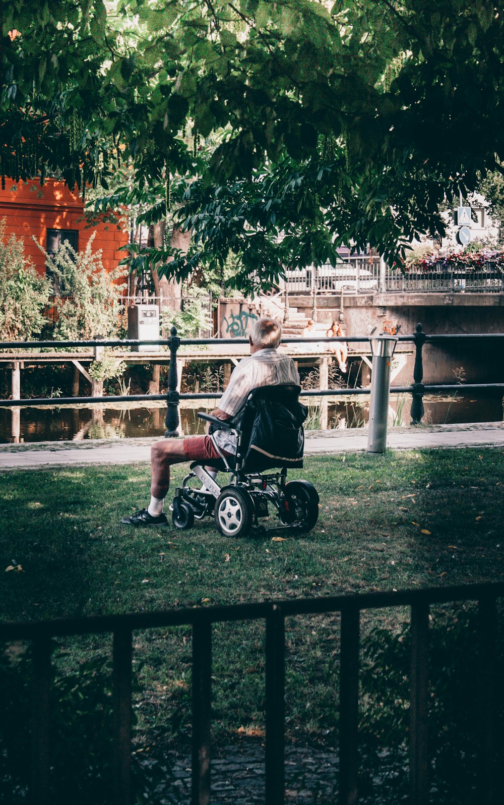 boy in black t-shirt riding on black and white motorcycle during daytime