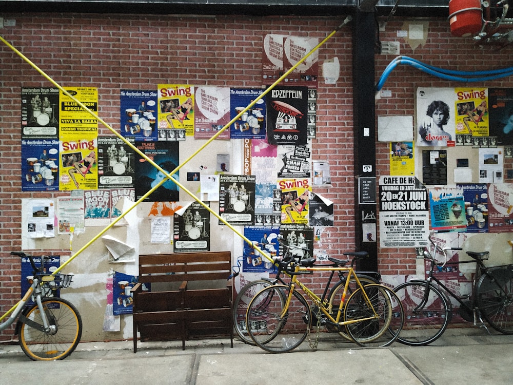 red bicycle parked beside brown wooden bench