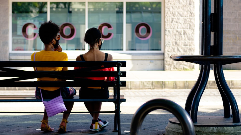 2 women sitting on bench