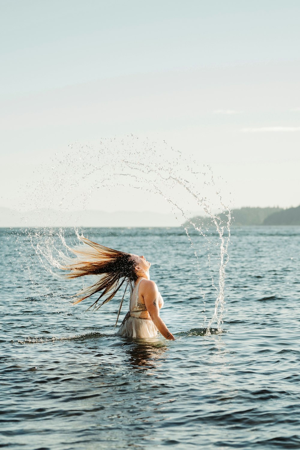 woman in white bikini top on water during daytime