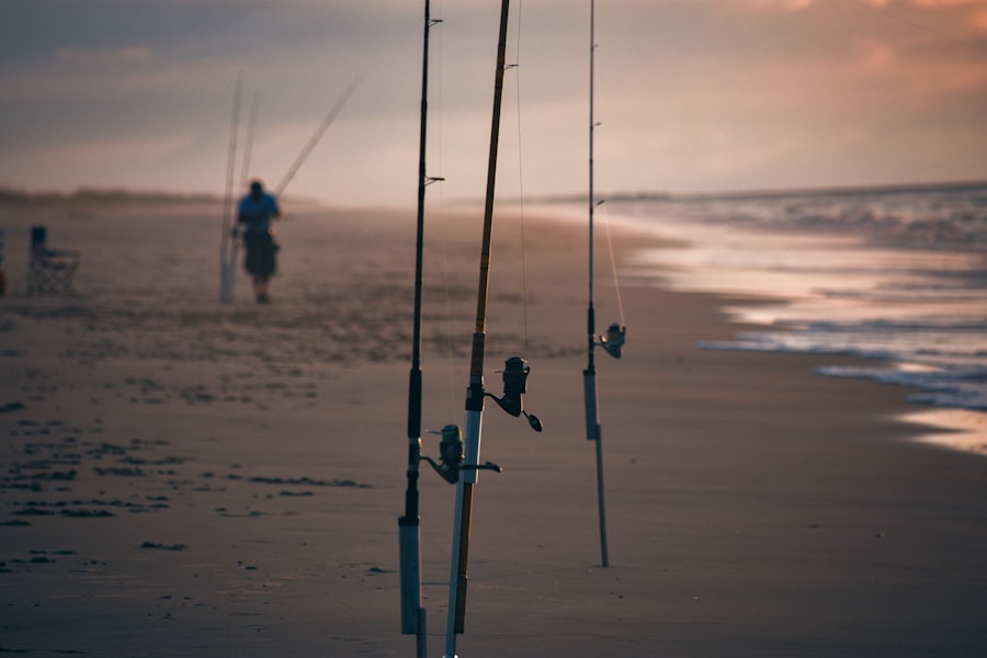 Two anglers casting from the beach at the ocean shoreline at dawn