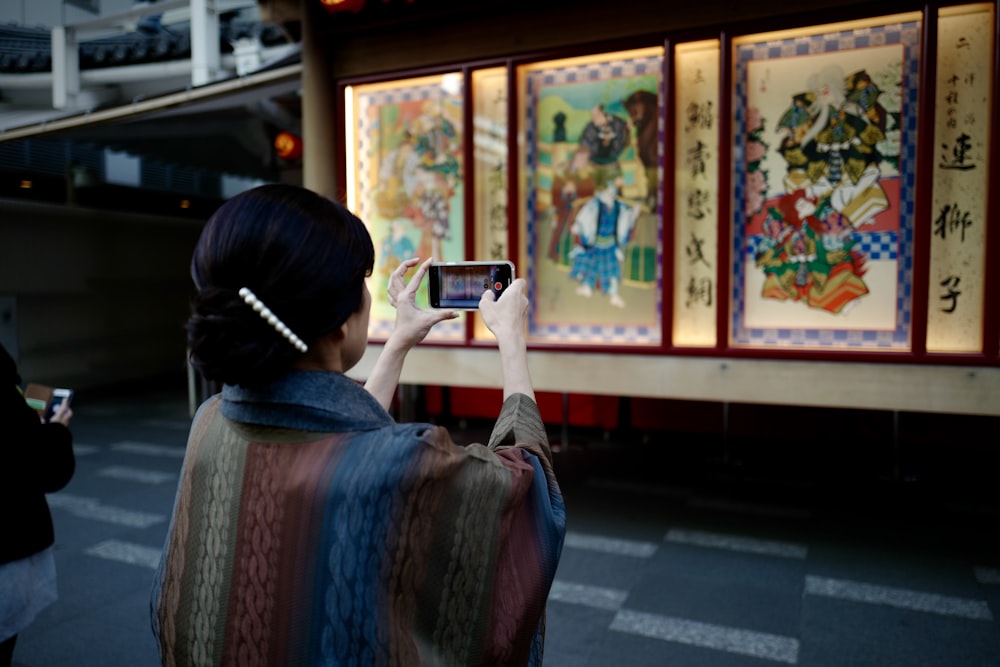 woman in white long sleeve shirt holding white smartphone