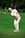 man in white crew neck t-shirt and gray pants holding golf club