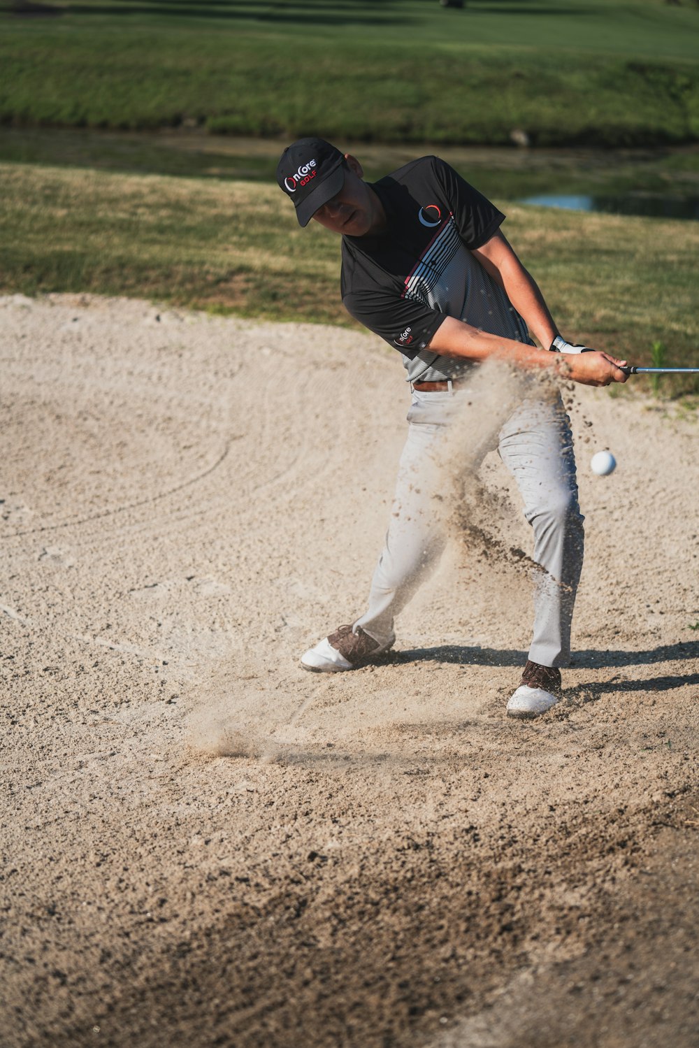 man in black t-shirt and white pants playing baseball during daytime