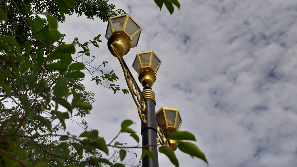 yellow lamp post under cloudy sky during daytime