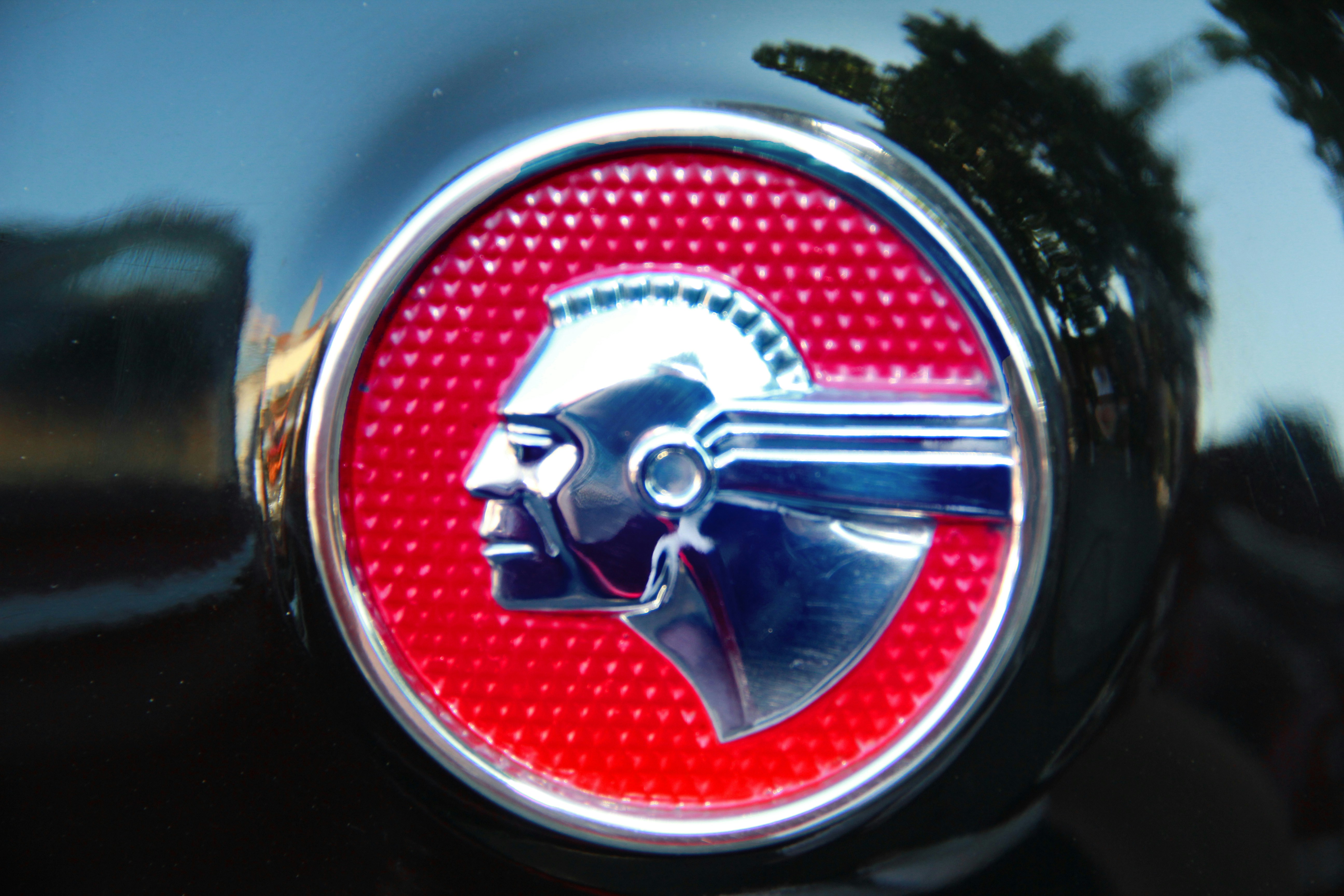 red and silver round car plate