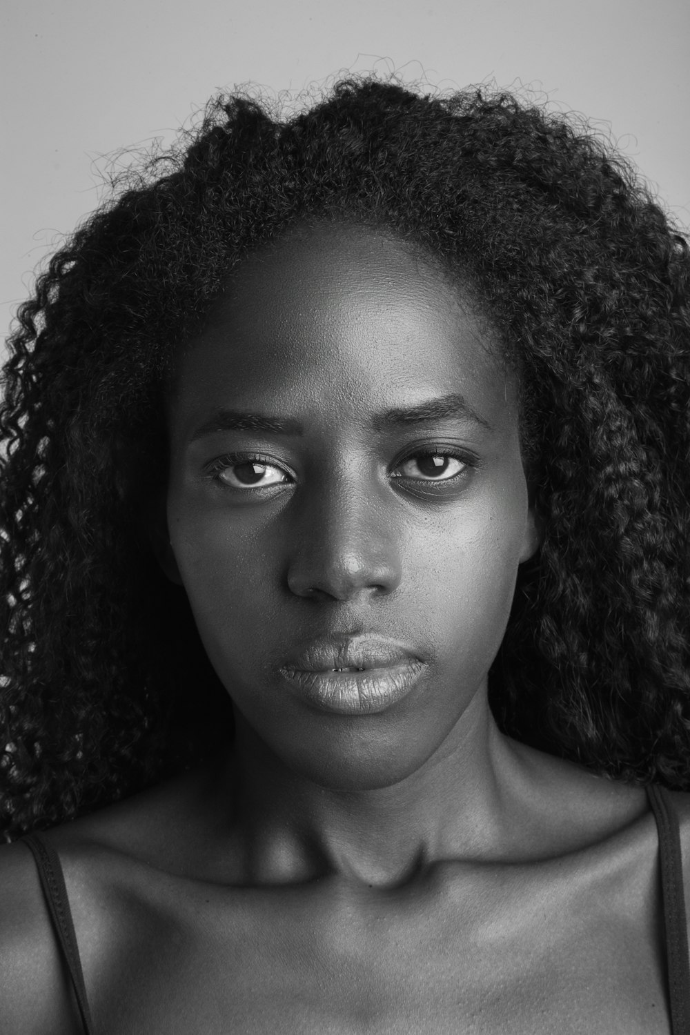 woman with curly hair in grayscale photography