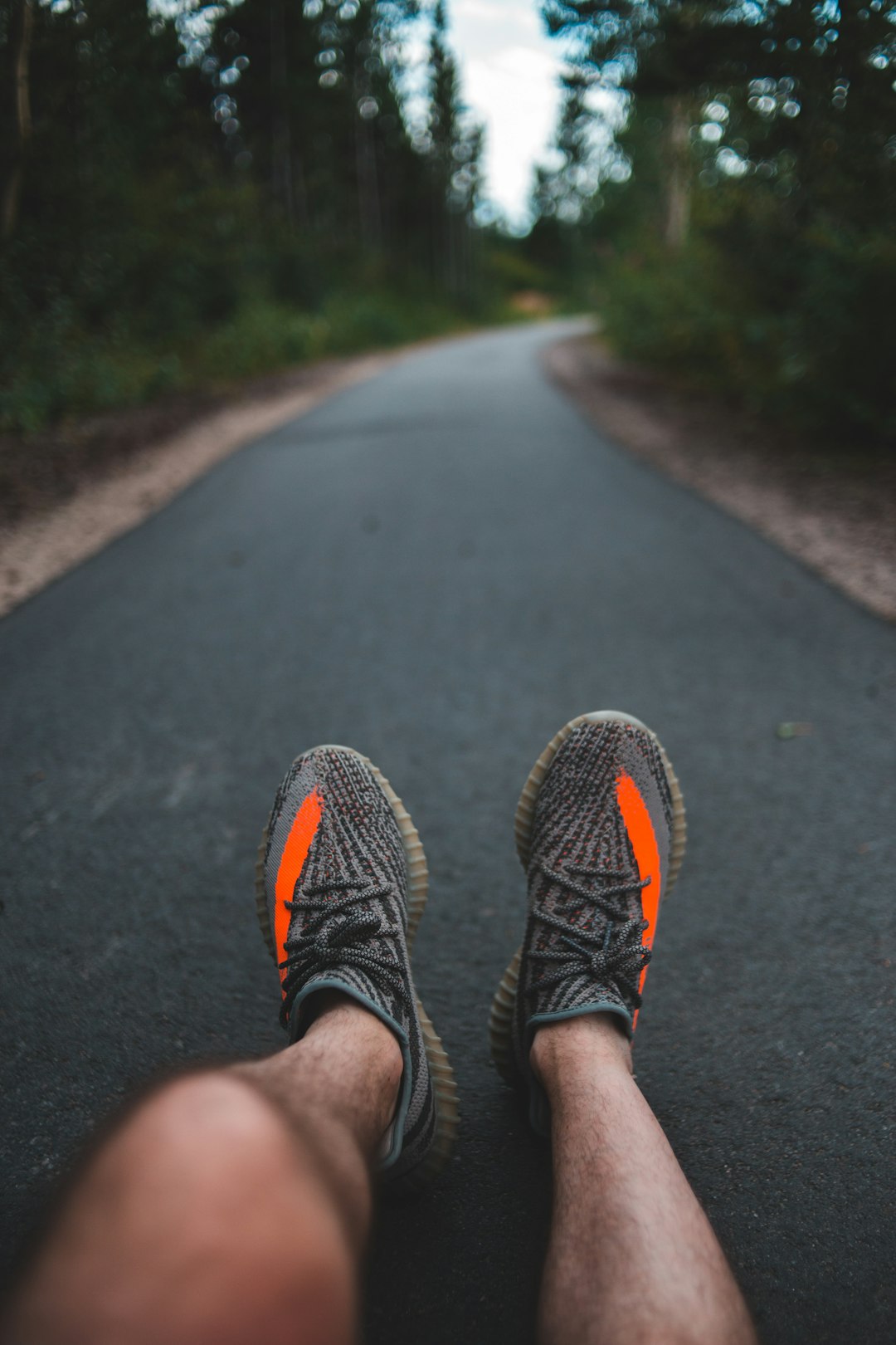 person wearing black and yellow sneakers