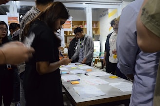 A diverse group of professionals engaged in a workshop setting, discussing and collaborating.