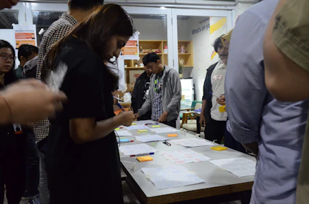 A vibrant workshop scene with engaged learners collaborating around a table.