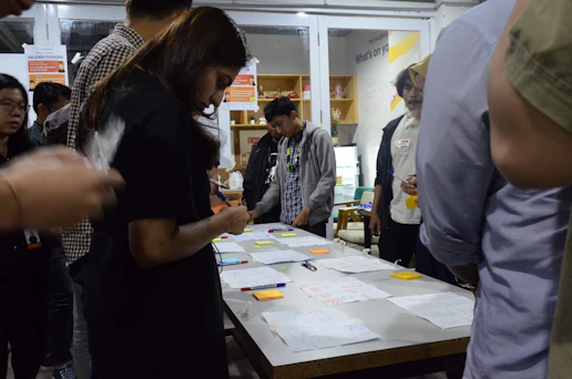 A diverse group engaged in an interactive leadership workshop, sharing ideas around a table.