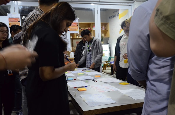 An inspiring image of people collaborating with a workbook.