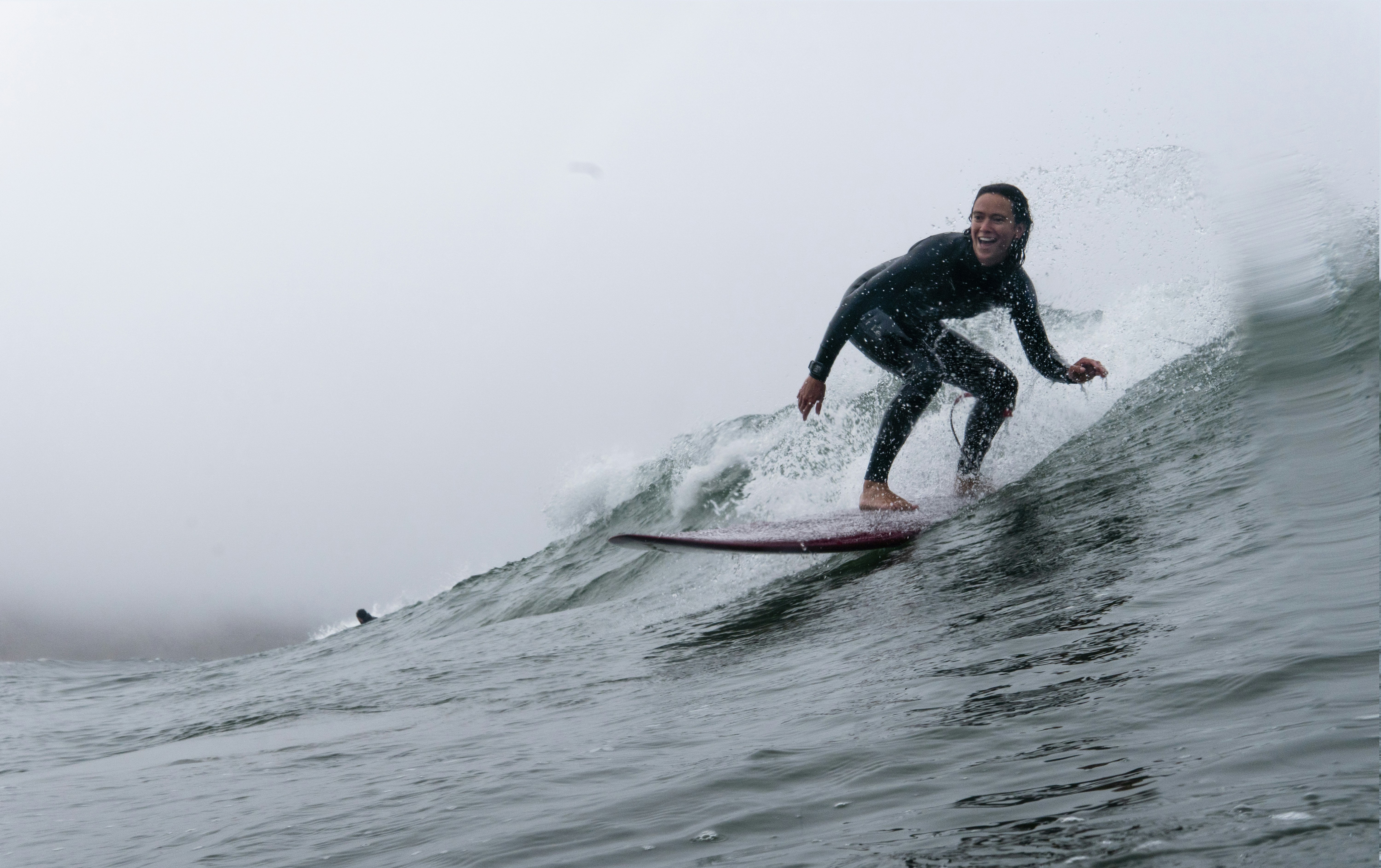 man in black wet suit riding on red surfboard on sea waves during daytime, Mellow surf day at Waddell California