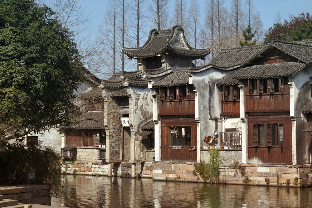 white and brown concrete building near body of water during daytime