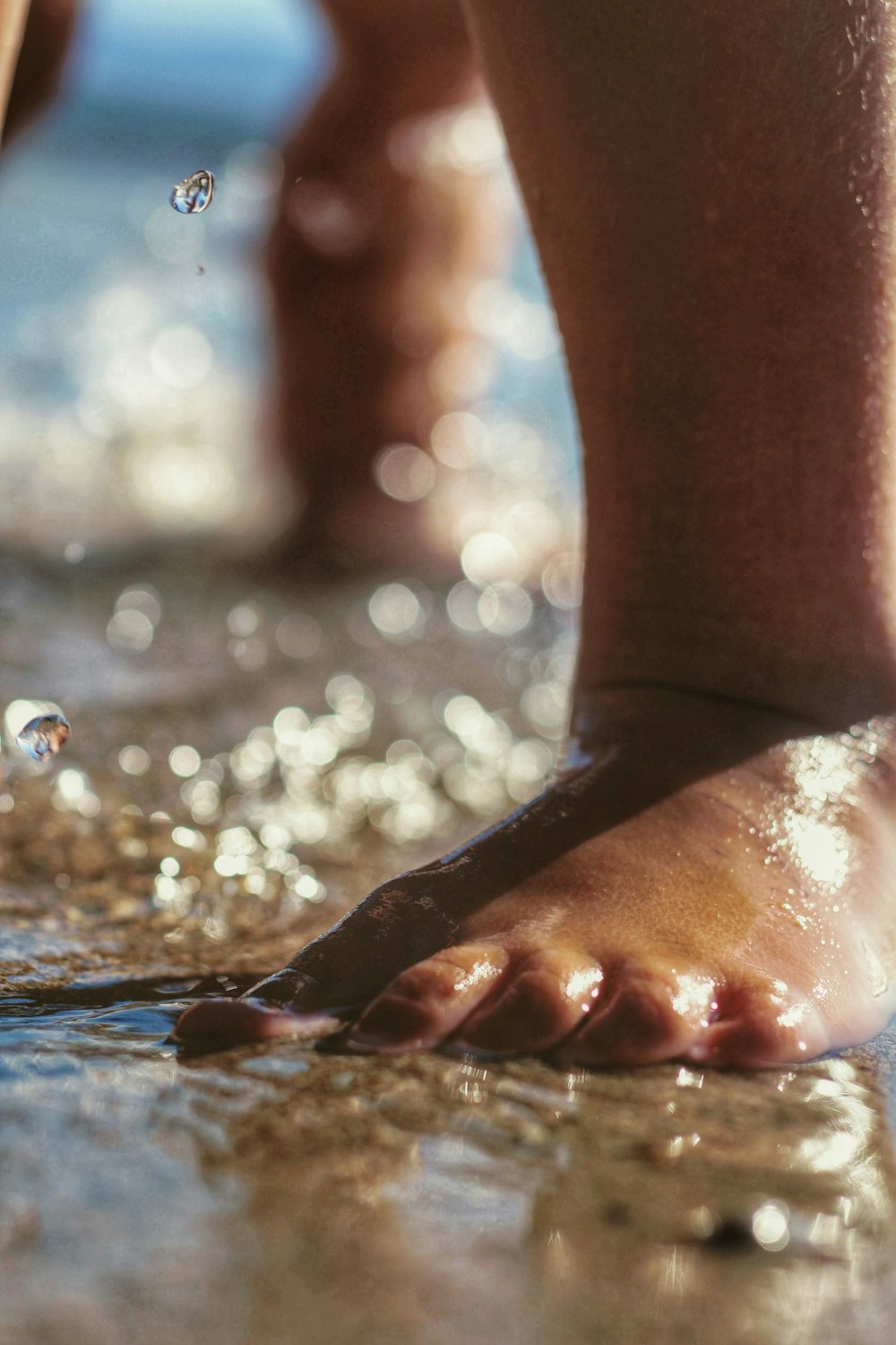 persons feet with water droplets