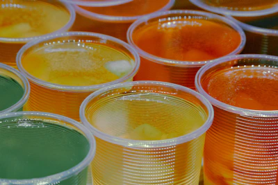 A refreshing fruit salad with colorful gelatin cubes in a clear dessert cup.