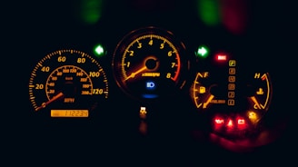 black and yellow analog speedometer