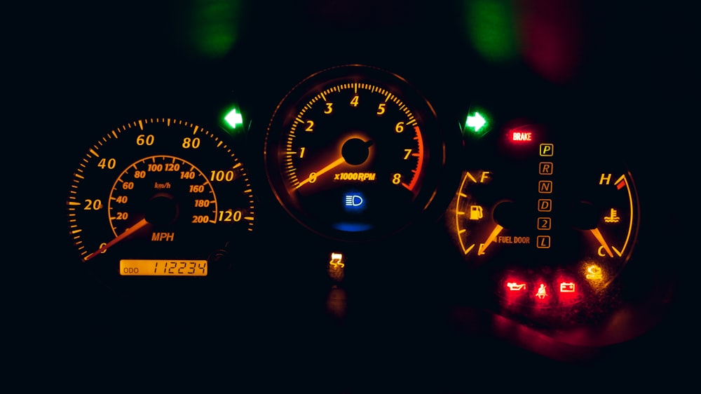 black and yellow analog speedometer