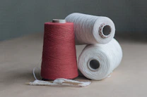 red thread on brown wooden table