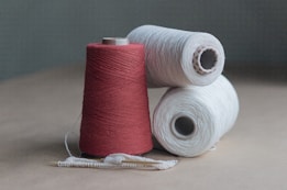 red thread on brown wooden table