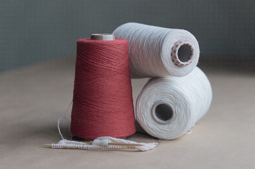 red thread on brown wooden table