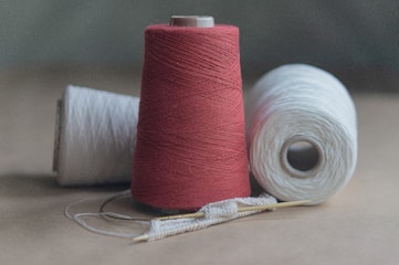 red thread on white paper