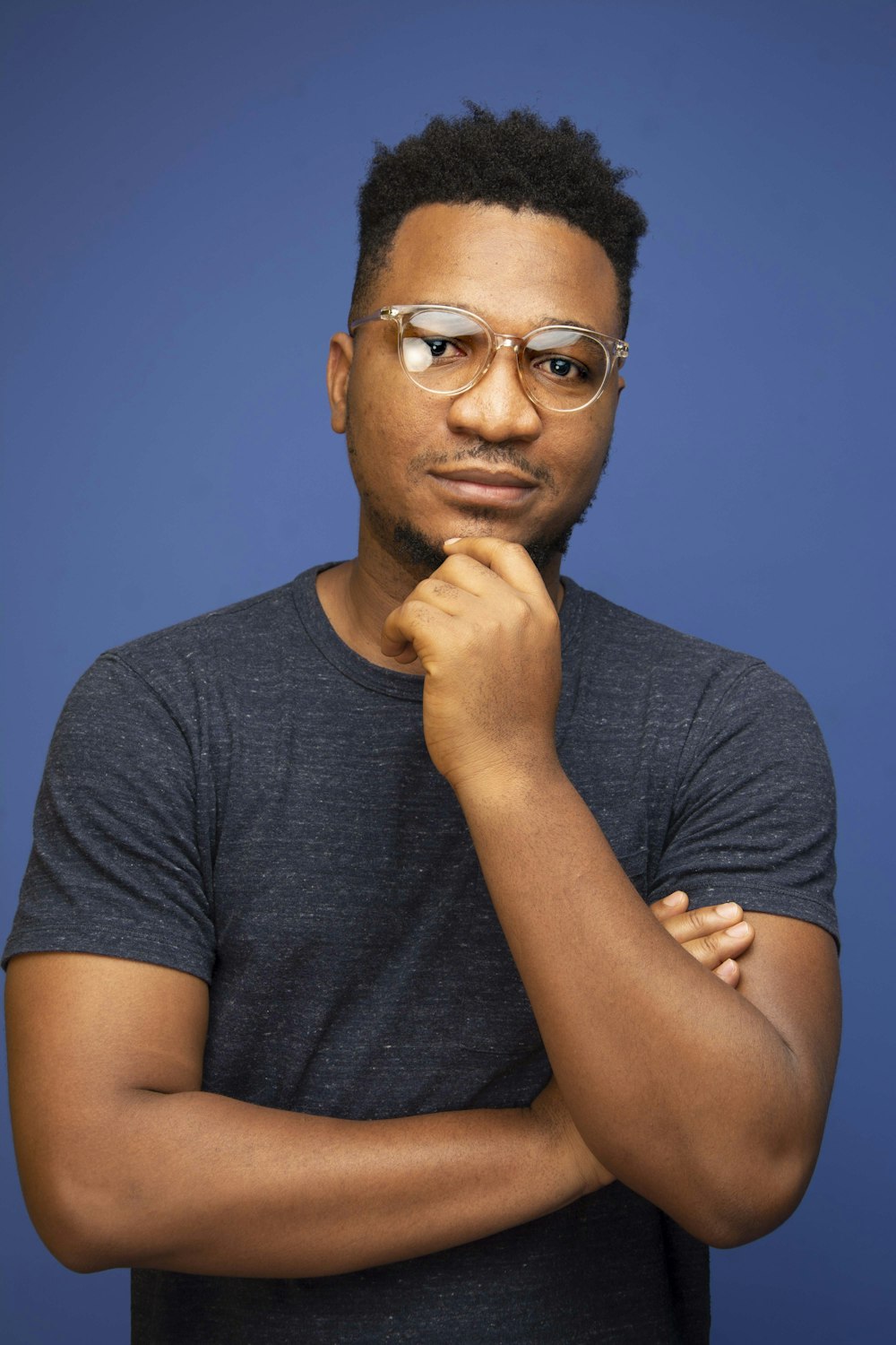 man in black crew neck t-shirt wearing black framed eyeglasses