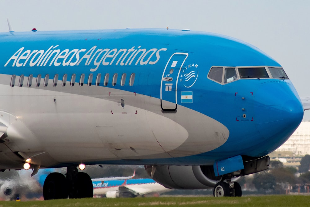 white and blue airplane during daytime