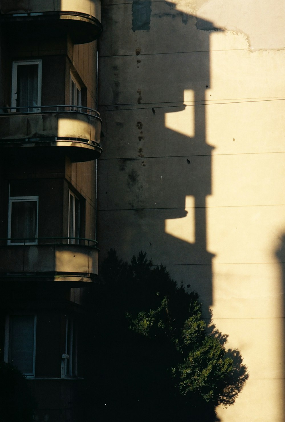 white concrete building near green trees during daytime