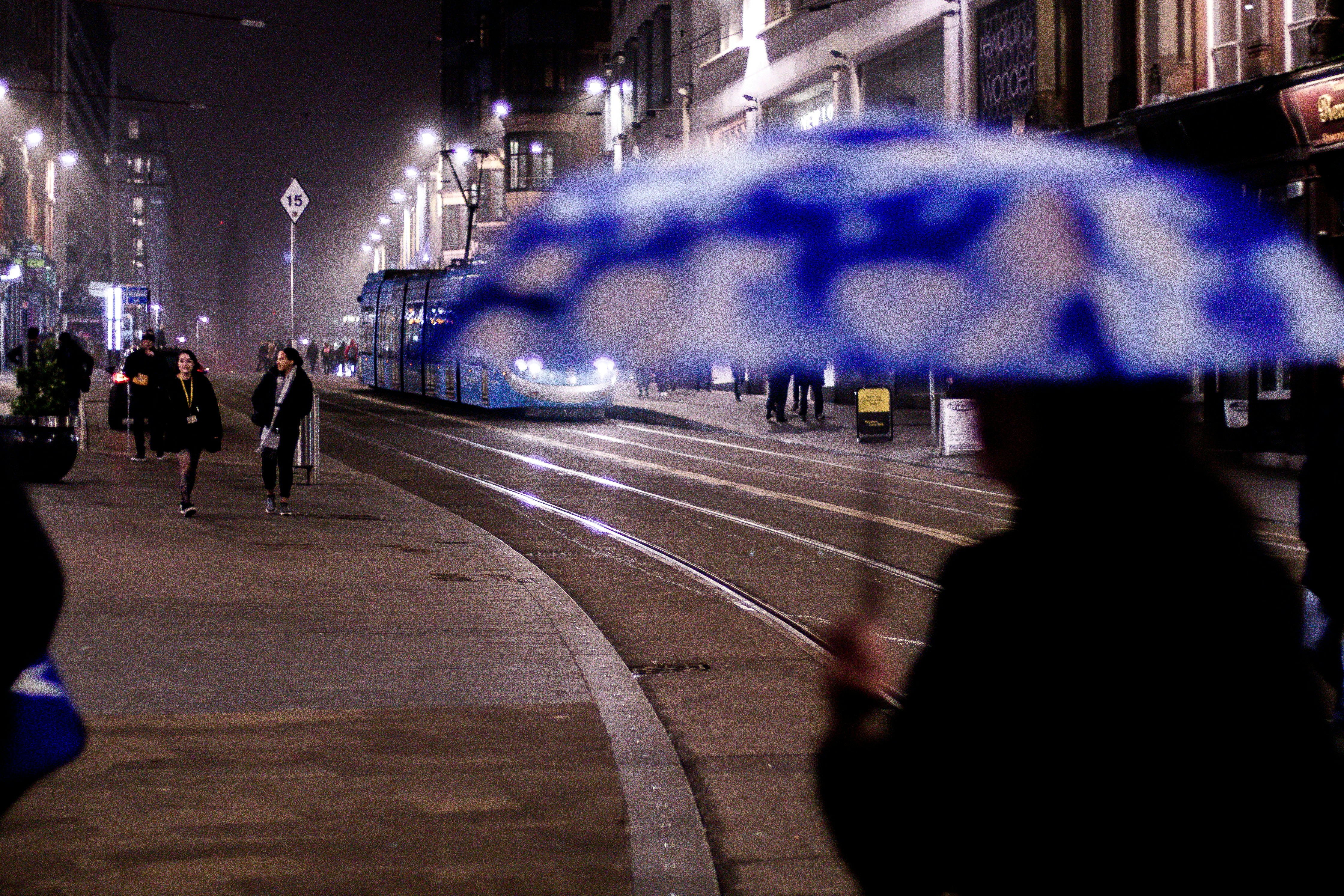 people walking on pedestrian lane during night time
