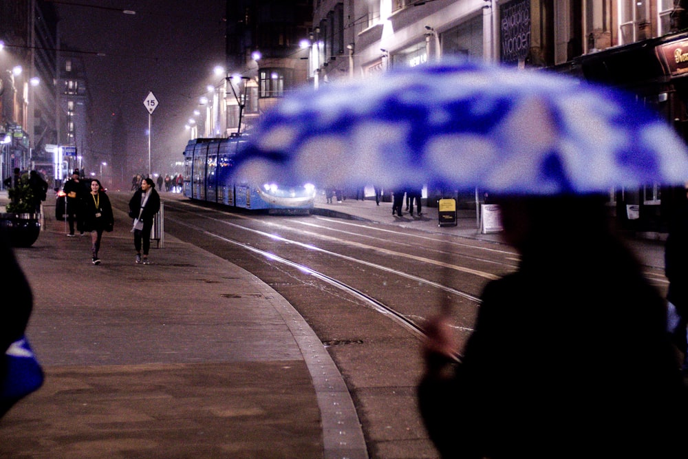 people walking on pedestrian lane during night time