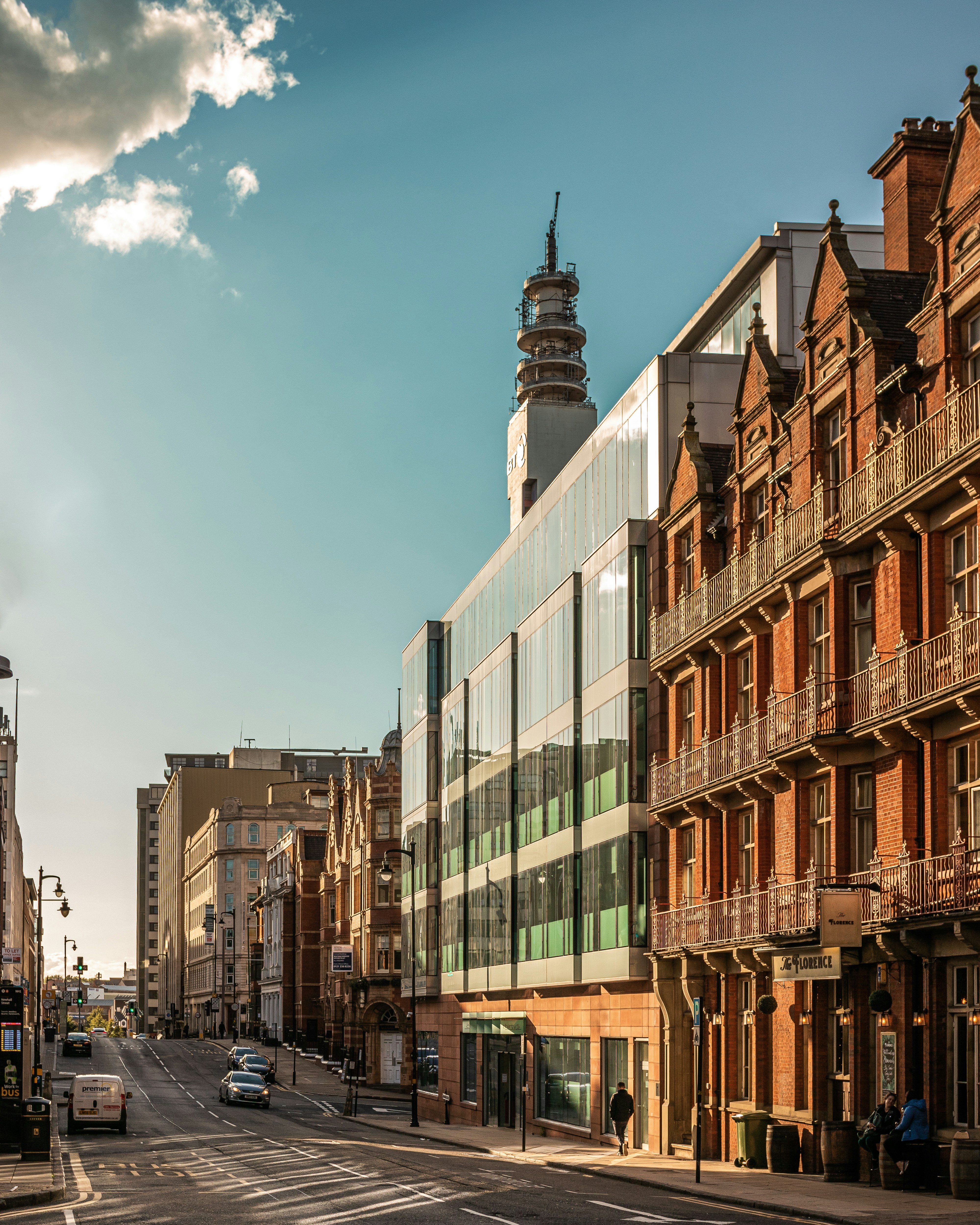 cars parked beside brown and white concrete building during daytime