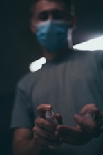 Close-up of hands using ozone generator for disinfecting a commercial space