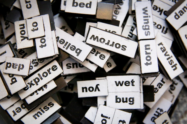 words written on white paper pieces scattered on a pile