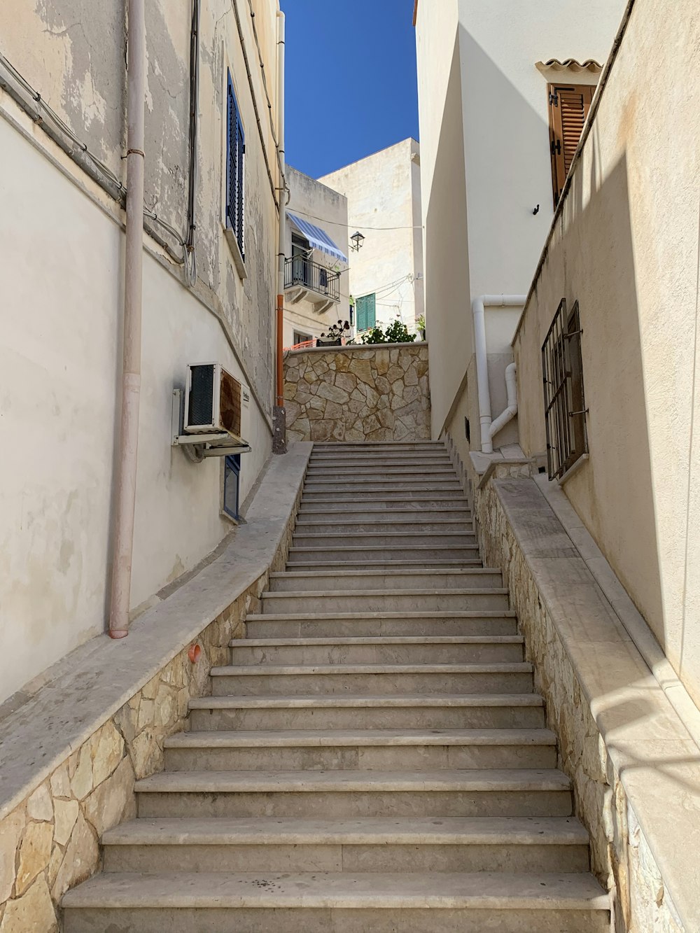 gray concrete staircase with brown wooden railings