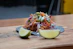 A joyful customer enjoying a colorful plate of traditional Mexican tacos at Santa Mordida.
