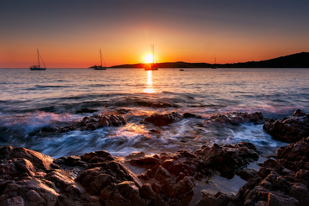 body of water during sunset