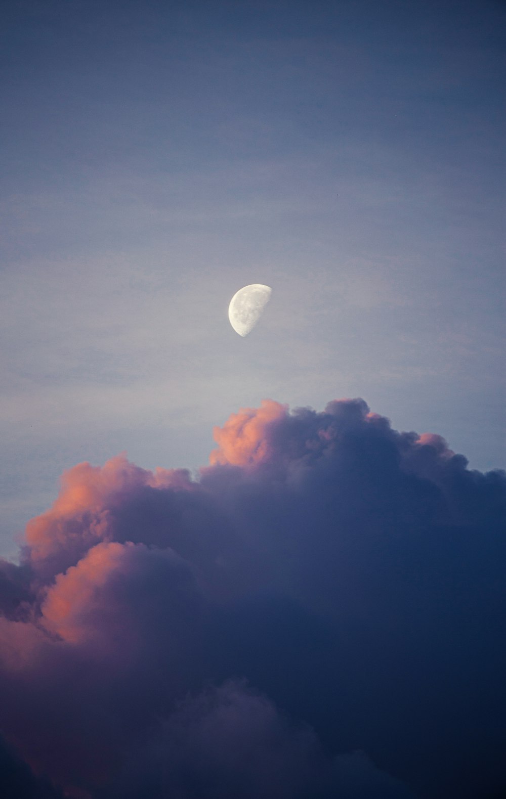 the moon is in the sky above the clouds