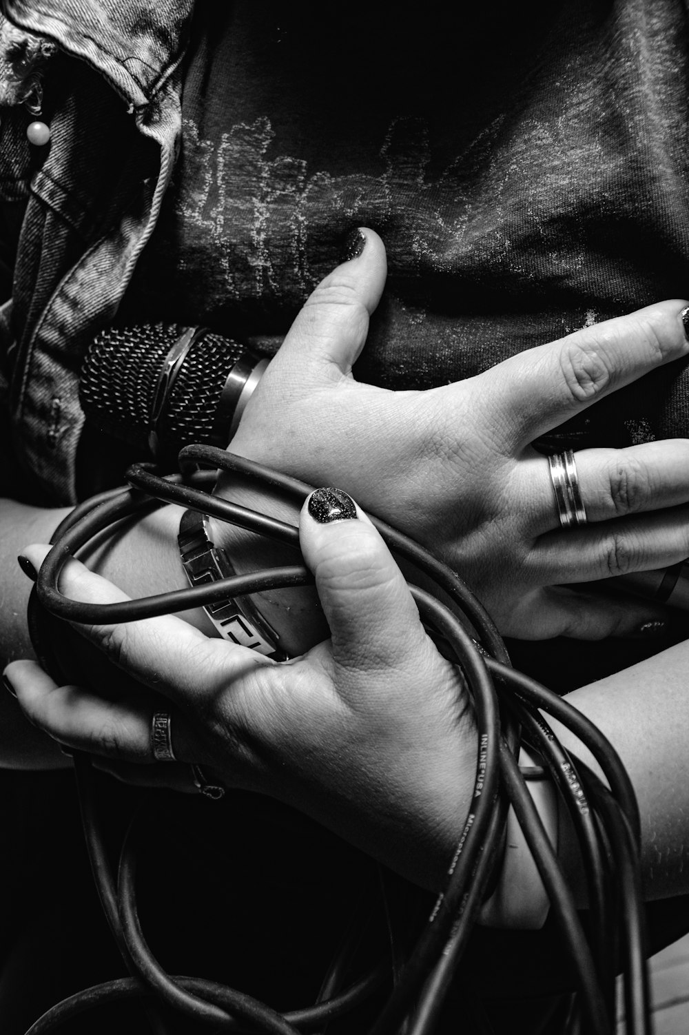 person wearing silver ring holding brass frame