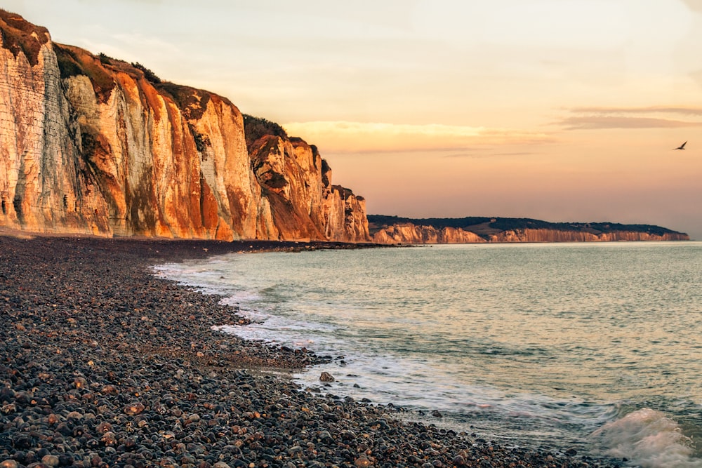 brown rock formation on sea shore during daytime