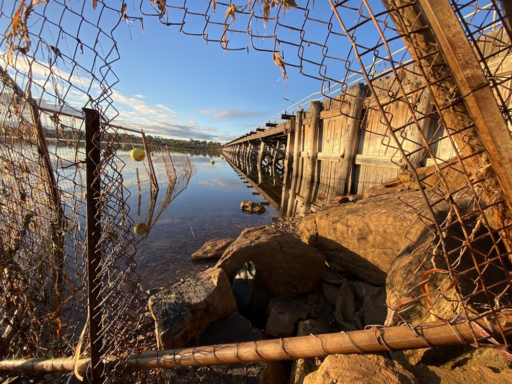 brown wooden bridge over blue sea during daytime