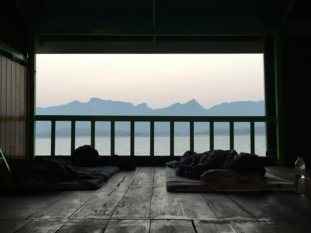 person lying on bed on top of the mountain