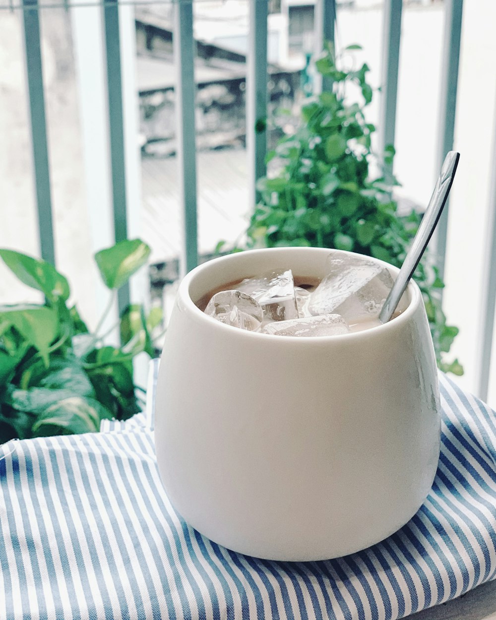 white ceramic mug with stainless steel spoon