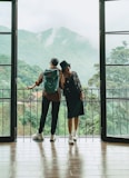 2 women standing on white wooden floor during daytime