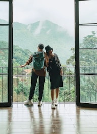 2 women standing on white wooden floor during daytime