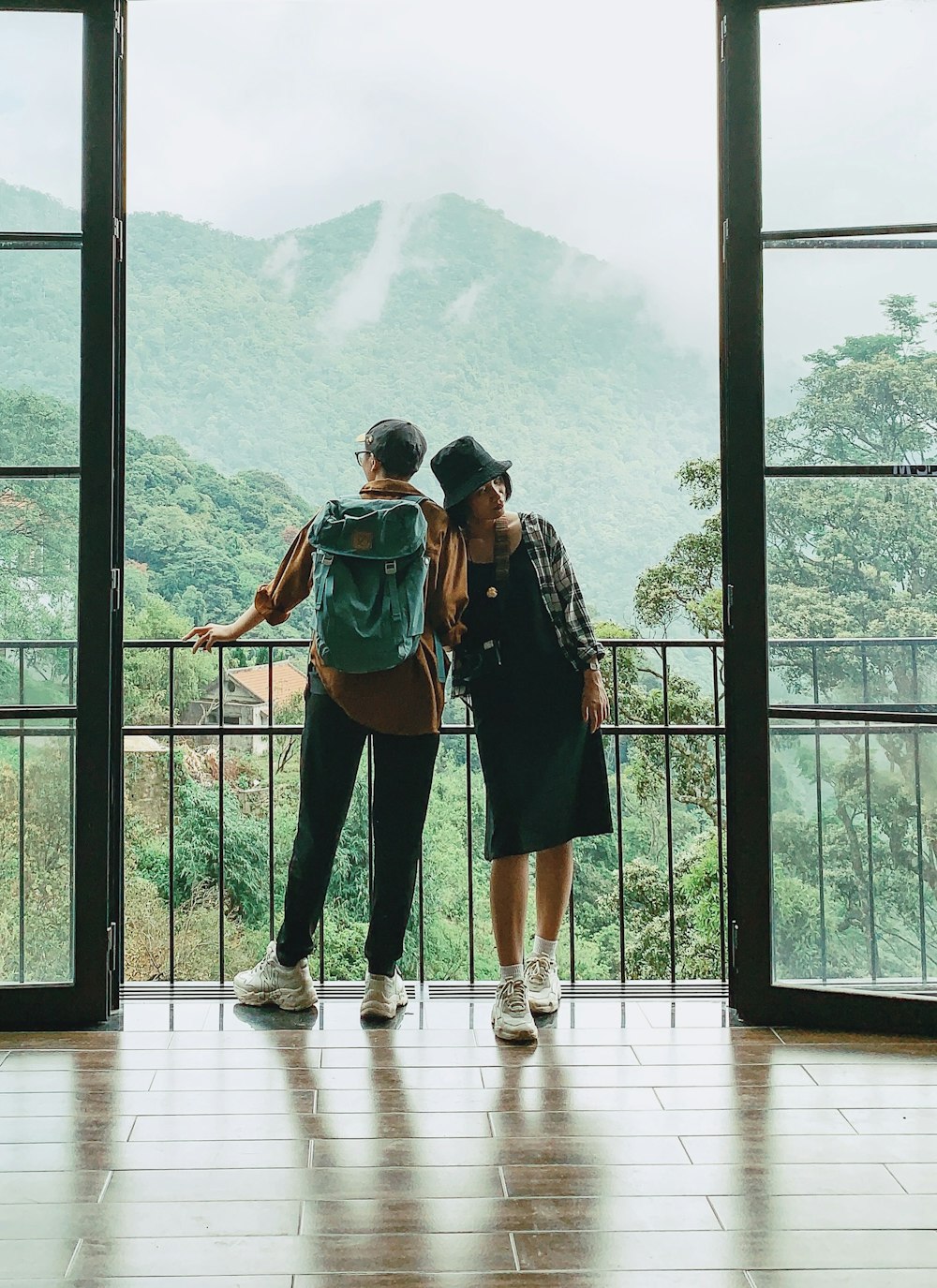 2 women standing on white wooden floor during daytime